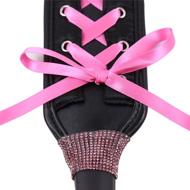 Close up view of Pink Ribbons on Bondage Paddle