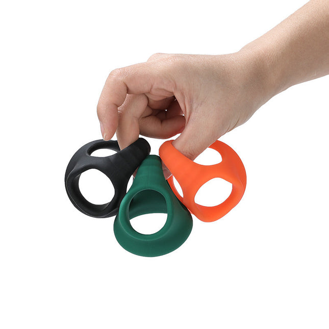 Elastic Silicone Cock Ring with hand holding colours in black, green and orange