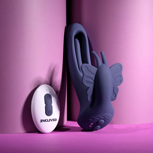 Evolved LORD OF THE WINGS Purple Butterfly Vibrator Standing next to White Remote Control