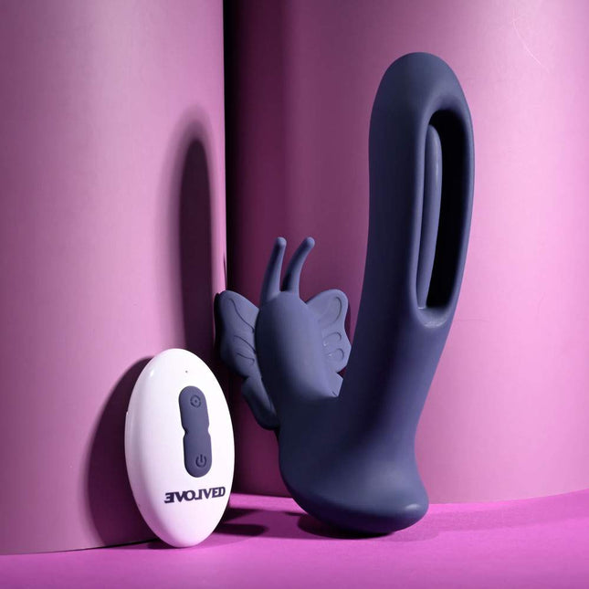 Evolved LORD OF THE WINGS Purple Butterfly Vibrator Standing upside next to Remote Control