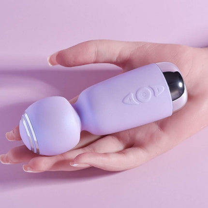 Female hand holding playboy massager sex toy