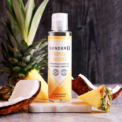 Gender X TROPICAL PASSION Flavoured Lube - 120 ml - Pineapple & Coconut Flavoured Water Based Lubricant Bottle with Fruit in Background