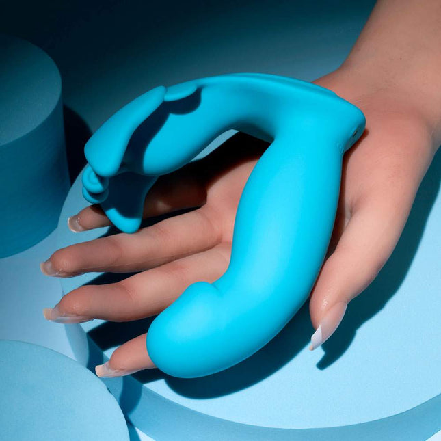 Hand holding blue Evolved SPREAD YOUR WINGS Butterfly Vibrator