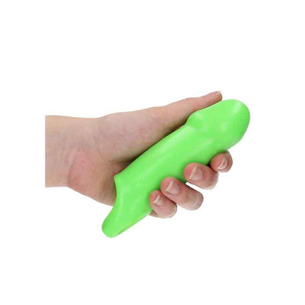 Mens hand holding glow in the dark penis sleeve