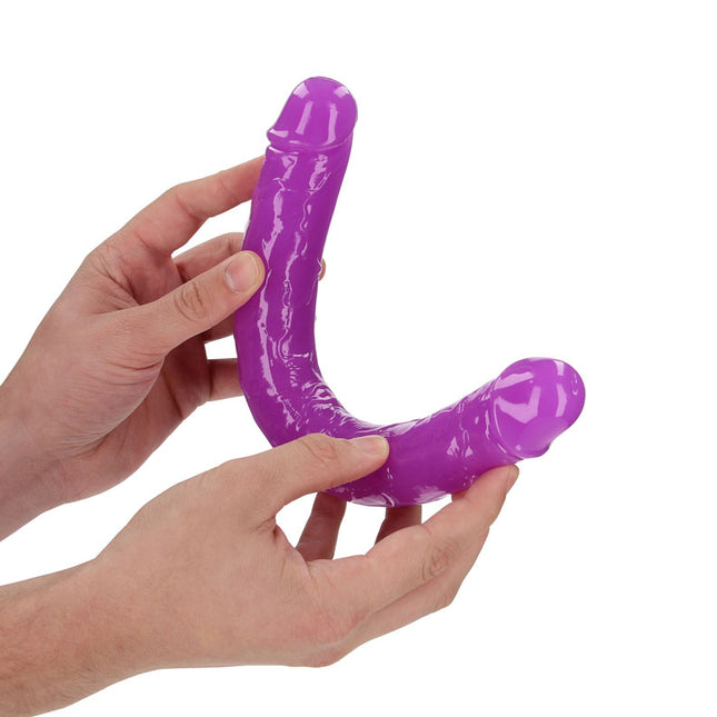 Hand holding REALROCK 12 Inch Curved Double Ended Dildo - Purple